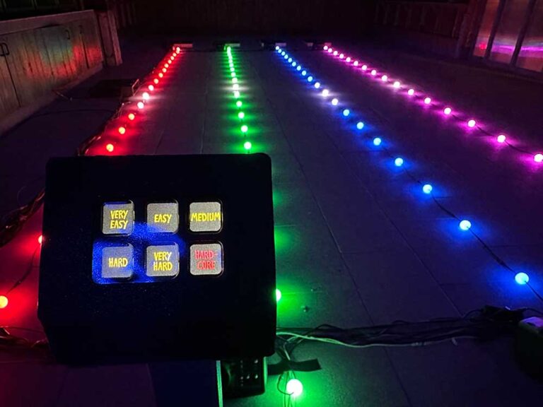LED-Lichtinstallation – Steuerpult vor mehrfarbigen LED-Streifen am Boden.